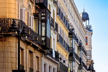 apartment-architecture-europe.jpg View of a building facade in Spain with windows and balconies.