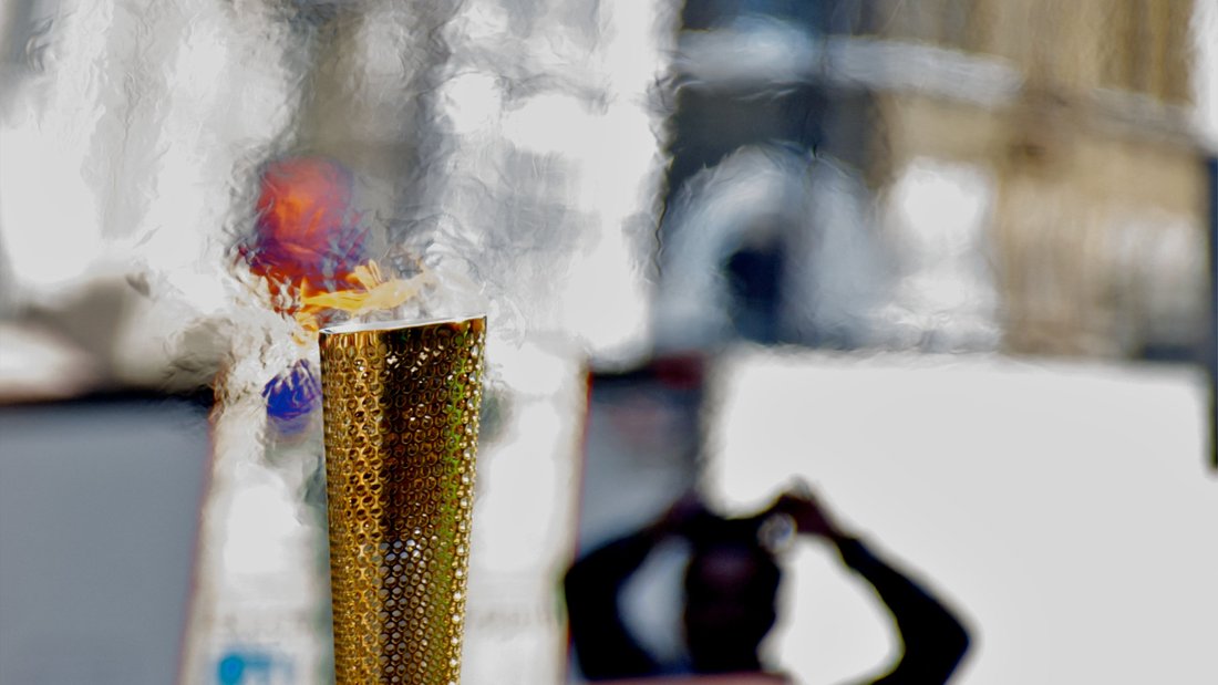 Olympic torch against a blurred background