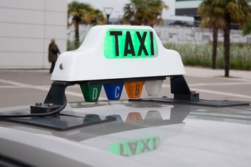Detailed view of a taxi sign affixed above the car