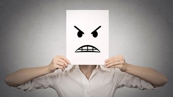 [Translate to English:] Une personne dont le visage est caché par un emoji en colère