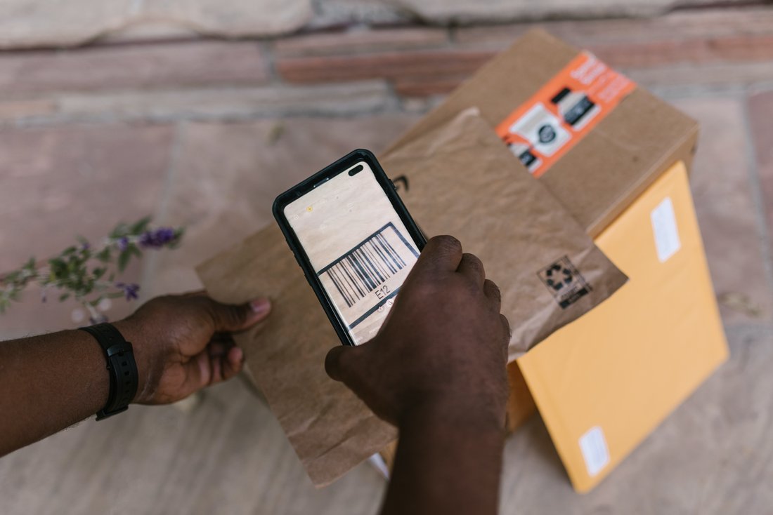 Delivery person scanning a package