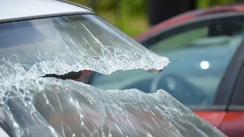car-windscreen-accident-reparation.jpg Close-up on the broken windshield of a vehicle.