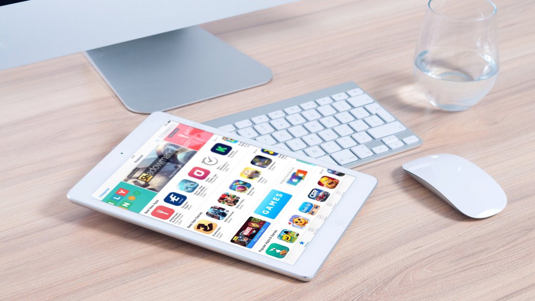 tablet-computer-games-internet.jpg A computer and a tablet with the screen on on a desk.