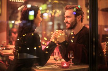 meeting.jpg Couple holding hands lovingly at a restaurant table.