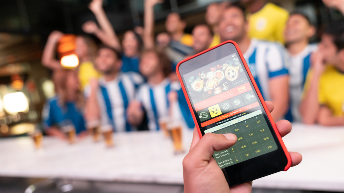 Online betting on smartphone while attending a sports event