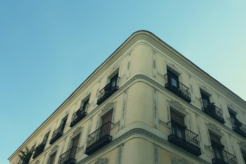 apartment-block-property.jpg View from the top of a building with windows and balconies.
