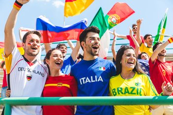 Supporters dressed in their country's colors cheer on the athletes