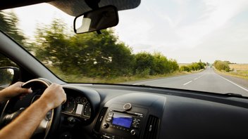 driving-road-countryside.jpg A person at the wheel of his car on an empty country road.