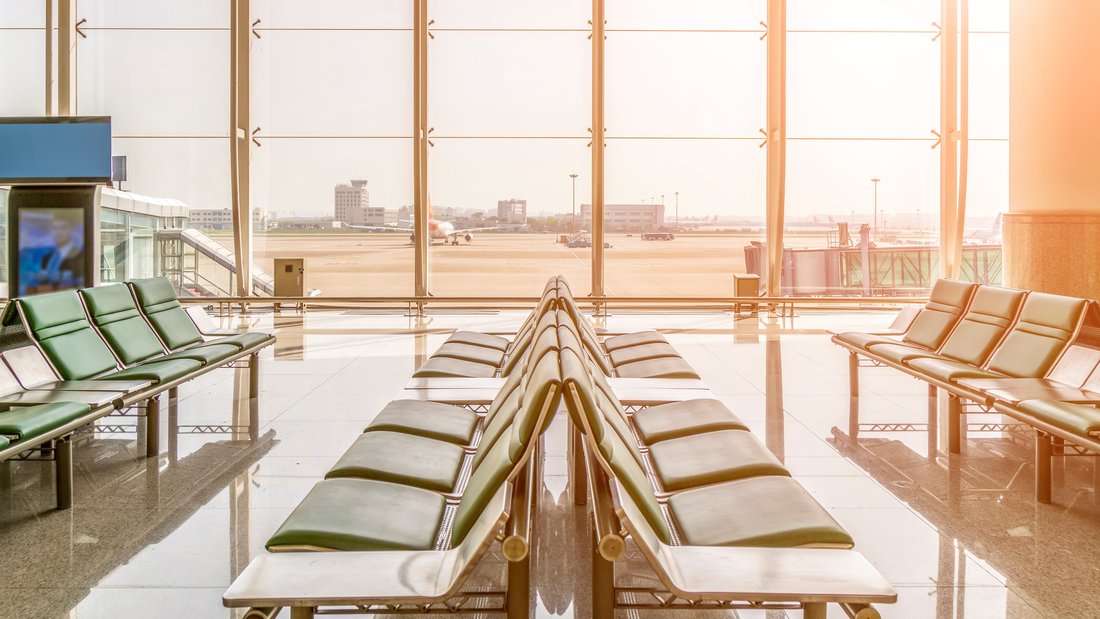 airport-boarding-flight.jpg A boarding room with a view of the runway in the background.