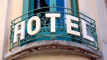 Balcony of a hotel with the letters ‘HOTEL’ on the railing