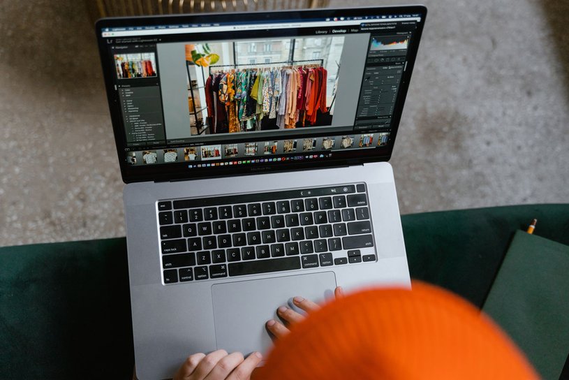 Buying second-hand clothes online open laptop with image of women's wardrobe