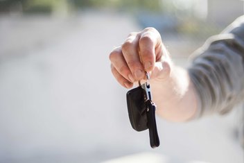 purchase-rental-keys-vehicle.jpg A person's hand holds out car keys.