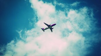 plane_flight.jpg Back view of an aeroplane in the sky.